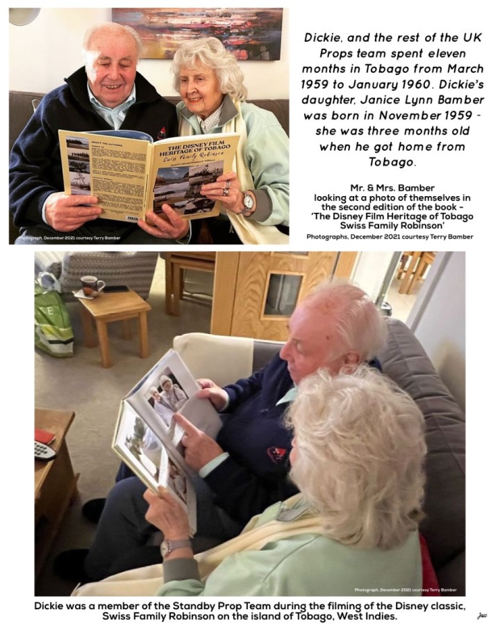 Mr. &amp; Mrs. Bamber looking at a photo of themselves in the second edition of the book - ‘The Disney Film Heritage of Tobago  Swiss Family Robinson’